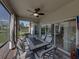 Lanai has a ceiling fan, comfortable table and seating, and a great view of the backyard at 5304 Nicklaus Dr, Winter Haven, FL 33884