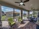 Screened lanai with multiple ceiling fans features outdoor seating and a view of the yard at 5304 Nicklaus Dr, Winter Haven, FL 33884