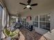 The screened-in lanai has a ceiling fan and a table with cushioned chairs overlooking the yard at 5304 Nicklaus Dr, Winter Haven, FL 33884