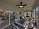 The screened-in lanai has a ceiling fan and a table with cushioned chairs overlooking the yard at 5304 Nicklaus Dr, Winter Haven, FL 33884