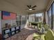 Covered lanai featuring brick flooring, casual seating, and an American flag on the back wall at 5304 Nicklaus Dr, Winter Haven, FL 33884