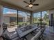 Screened in lanai featuring a ceiling fan, outdoor seating, and views of the backyard at 5304 Nicklaus Dr, Winter Haven, FL 33884