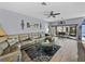 Spacious living room with a comfortable seating area, modern decor, and access to the screened patio at 5304 Nicklaus Dr, Winter Haven, FL 33884