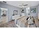 Spacious main bedroom features neutral colors, a ceiling fan, and a doorway view into the kitchen area at 5304 Nicklaus Dr, Winter Haven, FL 33884