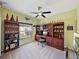Home office featuring neutral carpet, green walls, a ceiling fan and a large built-in unit at 5304 Nicklaus Dr, Winter Haven, FL 33884