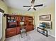 Home office featuring neutral carpet, green walls, a ceiling fan and a large built-in unit at 5304 Nicklaus Dr, Winter Haven, FL 33884