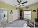 Home office featuring neutral carpet, green walls, a ceiling fan and a large built-in unit at 5304 Nicklaus Dr, Winter Haven, FL 33884