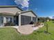 Enclosed patio featuring a brick floor, outdoor furniture, and a grill, perfect for entertaining at 5304 Nicklaus Dr, Winter Haven, FL 33884