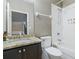 Bathroom featuring granite countertop, a vanity with dark cabinets, and a shower-tub at 629 Copeland Dr, Haines City, FL 33844