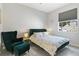 Stylishly furnished bedroom with green accents, floral bedding, and a cozy sitting area at 629 Copeland Dr, Haines City, FL 33844