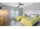 Bright bedroom featuring two twin beds, a ceiling fan, and tiled floors at 629 Copeland Dr, Haines City, FL 33844