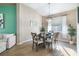 Cozy dining room featuring a modern chandelier, a stylish mirror, and a view of the adjacent living area at 629 Copeland Dr, Haines City, FL 33844