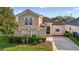 Inviting home exterior with lush landscaping, a manicured lawn, and a welcoming entrance with decorative trim at 629 Copeland Dr, Haines City, FL 33844