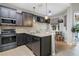 Modern kitchen with stainless steel appliances and a breakfast bar with seating overlooking the pool at 629 Copeland Dr, Haines City, FL 33844