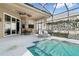 Relax on the lanai that features a covered outdoor dining and lounge area next to the pool at 629 Copeland Dr, Haines City, FL 33844