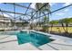 Sparkling pool and spa surrounded by lush landscaping and a screened enclosure at 629 Copeland Dr, Haines City, FL 33844
