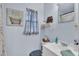 This bathroom features light-blue walls, framed art, and a white sink with a decorative mirror at 634 Formosa Pl, Bartow, FL 33830