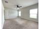 Spacious bedroom with neutral carpet, ceiling fan, and plenty of natural light at 663 Lucerne Blvd, Winter Haven, FL 33881