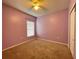 Cozy bedroom with neutral carpet, ceiling fan and window with blind providing ample natural light at 663 Lucerne Blvd, Winter Haven, FL 33881