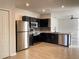Modern kitchen features stainless steel appliances, dark cabinetry, and tile flooring at 663 Lucerne Blvd, Winter Haven, FL 33881