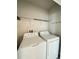 Practical laundry room with washer, dryer, and wire shelving at 663 Lucerne Blvd, Winter Haven, FL 33881