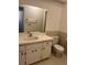 Bathroom features vanity, toilet, and large mirror at 683 Broadmoor Cir # 683, Winter Haven, FL 33884