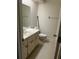 Bathroom features vanity, toilet, and large mirror at 683 Broadmoor Cir # 683, Winter Haven, FL 33884