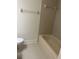 Bathroom with a tiled tub and toilet at 683 Broadmoor Cir # 683, Winter Haven, FL 33884