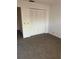 Carpeted bedroom featuring white closet doors at 683 Broadmoor Cir # 683, Winter Haven, FL 33884