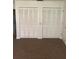 Carpeted bedroom featuring white closet doors at 683 Broadmoor Cir # 683, Winter Haven, FL 33884