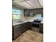 Well-lit kitchen featuring stainless steel appliances, modern cabinets and tiled floor at 683 Broadmoor Cir # 683, Winter Haven, FL 33884
