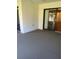 Carpeted patio with sliding glass doors and a stucco wall at 683 Broadmoor Cir # 683, Winter Haven, FL 33884