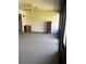 Carpeted lanai featuring light colored walls, storage units, and large windows and sliding doors at 683 Broadmoor Cir # 683, Winter Haven, FL 33884