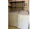 The laundry room has a washer, dryer, and shelves at 683 Broadmoor Cir # 683, Winter Haven, FL 33884