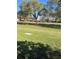 Manicured lawn with mature trees and residences in the background at 683 Broadmoor Cir # 683, Winter Haven, FL 33884