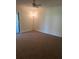 Cozy living room featuring neutral carpet and a ceiling fan at 683 Broadmoor Cir # 683, Winter Haven, FL 33884