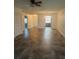 Spacious living room with tile floors, ceiling fan, and access to the kitchen at 683 Broadmoor Cir # 683, Winter Haven, FL 33884