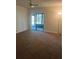 Living room featuring neutral carpet and sliding door access to the screened lanai at 683 Broadmoor Cir # 683, Winter Haven, FL 33884