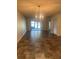 Bright and airy living room with sliding glass doors, tile floors, and chandelier at 683 Broadmoor Cir # 683, Winter Haven, FL 33884