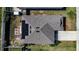 Aerial view showcasing the roof, solar panels, skylights, backyard patio furniture, and a fire pit at 708 Simone Ct, Haines City, FL 33844
