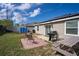 Well-maintained backyard featuring a brick patio, grill, and ample green space at 708 Simone Ct, Haines City, FL 33844