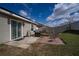 Relaxing backyard patio area with a grill, picnic table, and seating at 708 Simone Ct, Haines City, FL 33844