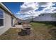 Expansive backyard featuring a fire pit, grill, patio area, and ample space for outdoor activities at 708 Simone Ct, Haines City, FL 33844