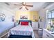 Cozy bedroom featuring a ceiling fan, comfortable bed, and decorative artwork at 708 Simone Ct, Haines City, FL 33844