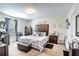 Cozy bedroom featuring a queen-size bed with a padded headboard and a large window at 708 Simone Ct, Haines City, FL 33844