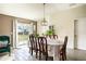Cozy dining area with a traditional table setting, sliding door access to the backyard, and neutral decor at 708 Simone Ct, Haines City, FL 33844