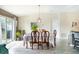 Elegant dining room featuring a spacious table, stylish decor, and a sliding glass door to the patio at 708 Simone Ct, Haines City, FL 33844