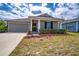 Charming one-story home with well-manicured lawn and attached two-car garage at 708 Simone Ct, Haines City, FL 33844