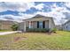 Attractive house with a lush front lawn, two-car garage, and manicured shrubs enhancing its curb appeal at 708 Simone Ct, Haines City, FL 33844