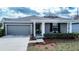 Attractive home with a well-kept lawn, two-car garage, covered entry, and freshly mulched flower beds at 708 Simone Ct, Haines City, FL 33844